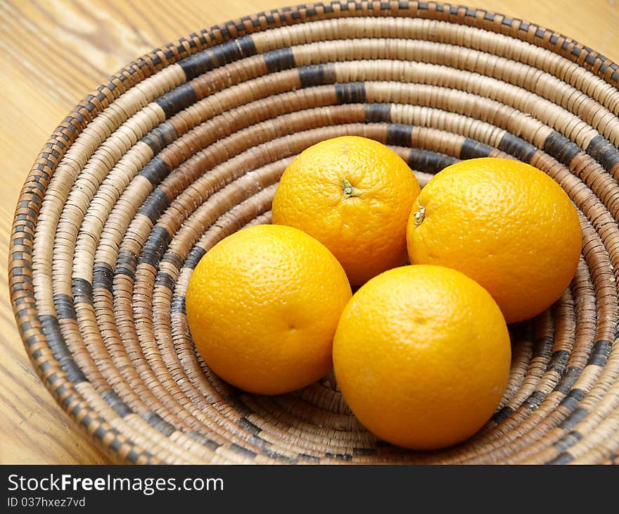 Four oranges in a basket