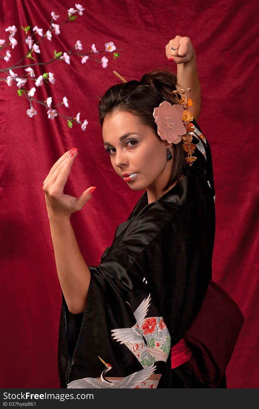 Japanese girl in traditional clothes posing to the camera