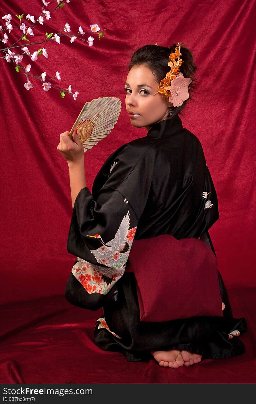 Japanese girl in traditional clothes posing to the camera