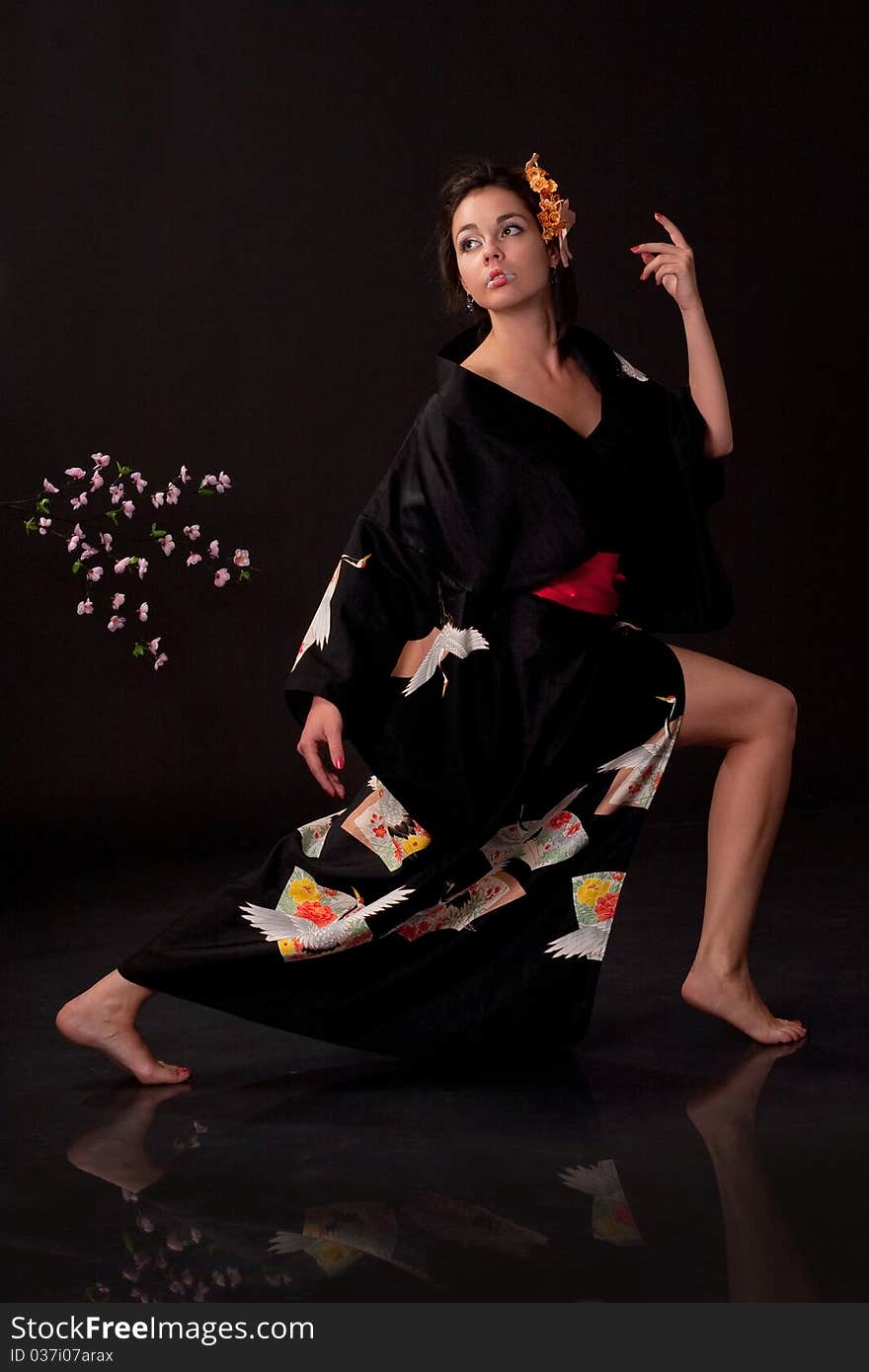 Japanese girl in traditional clothes posing to the camera