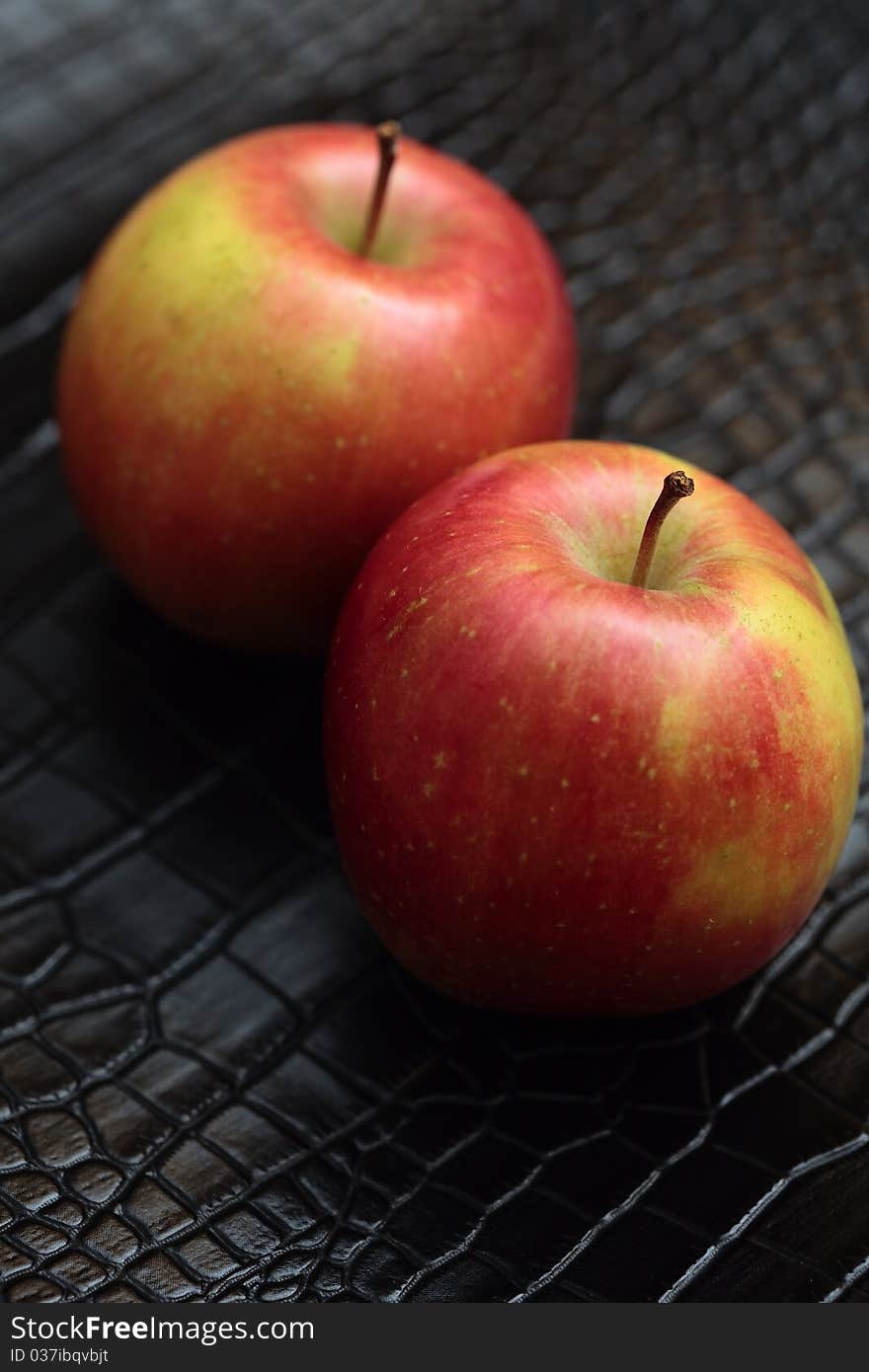 Two red apples on a black background. Two red apples on a black background