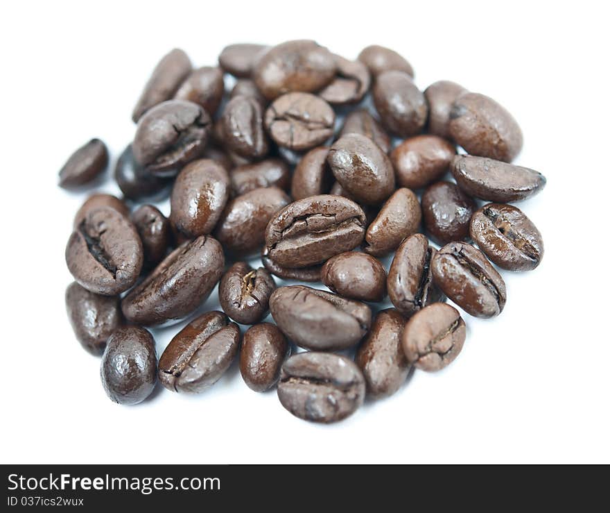 Coffee beans pile close up isolated on white