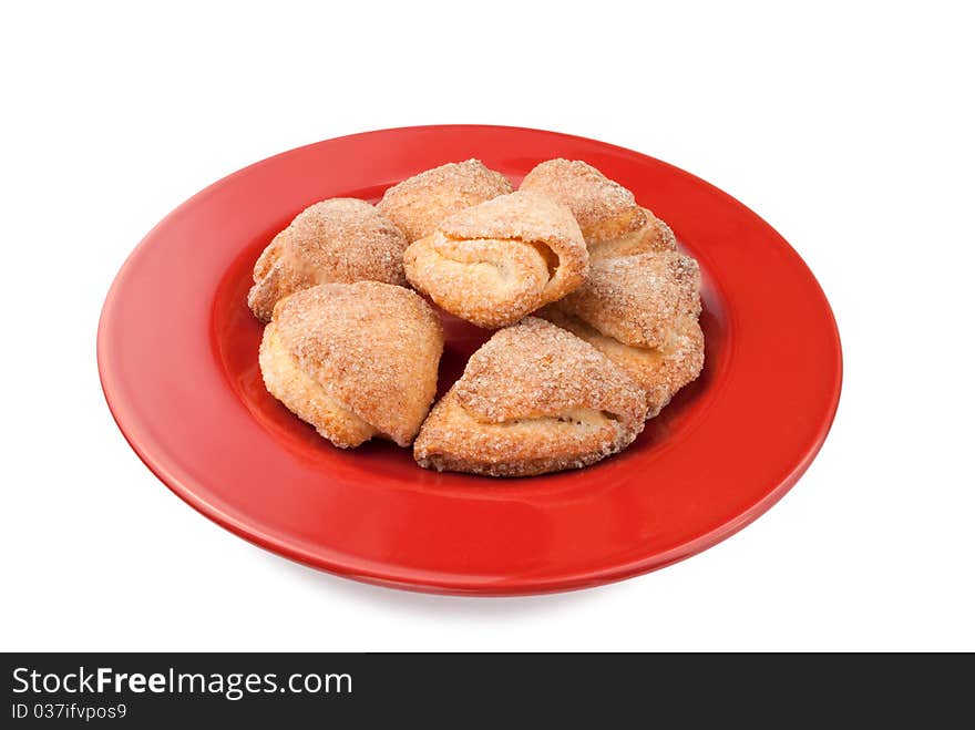 Cookies on red plate on a white background