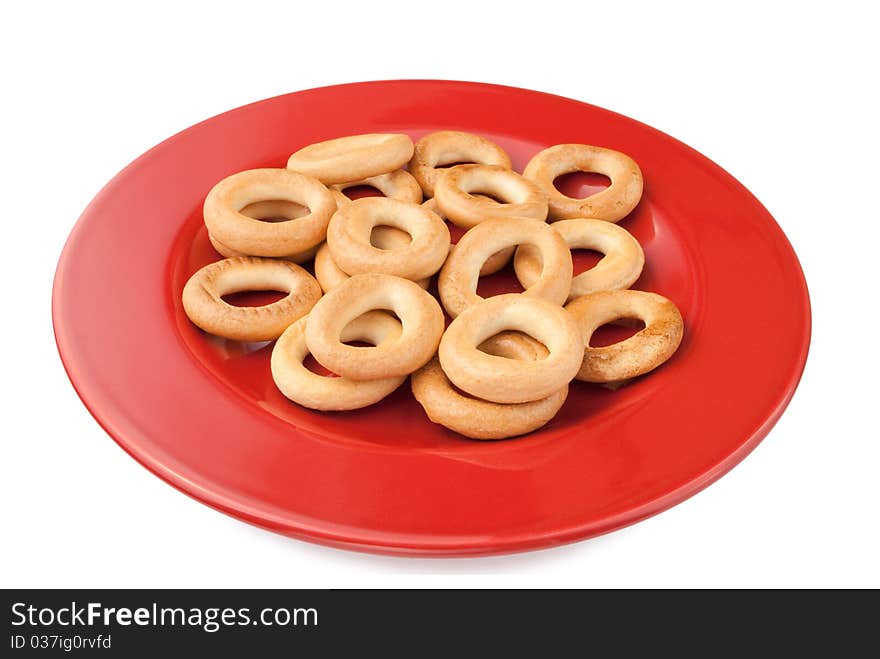 Round cracknel on red plate on a white background