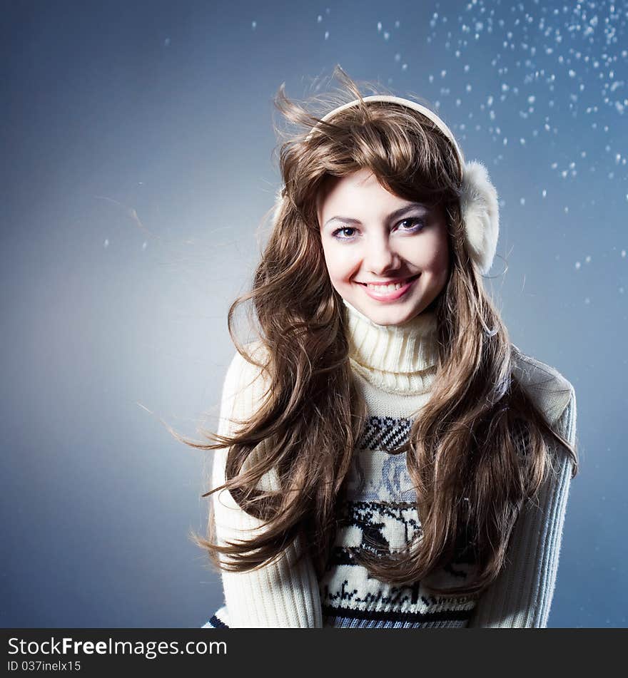 Young beautiful girl rejoices to snow, On a dark blue background