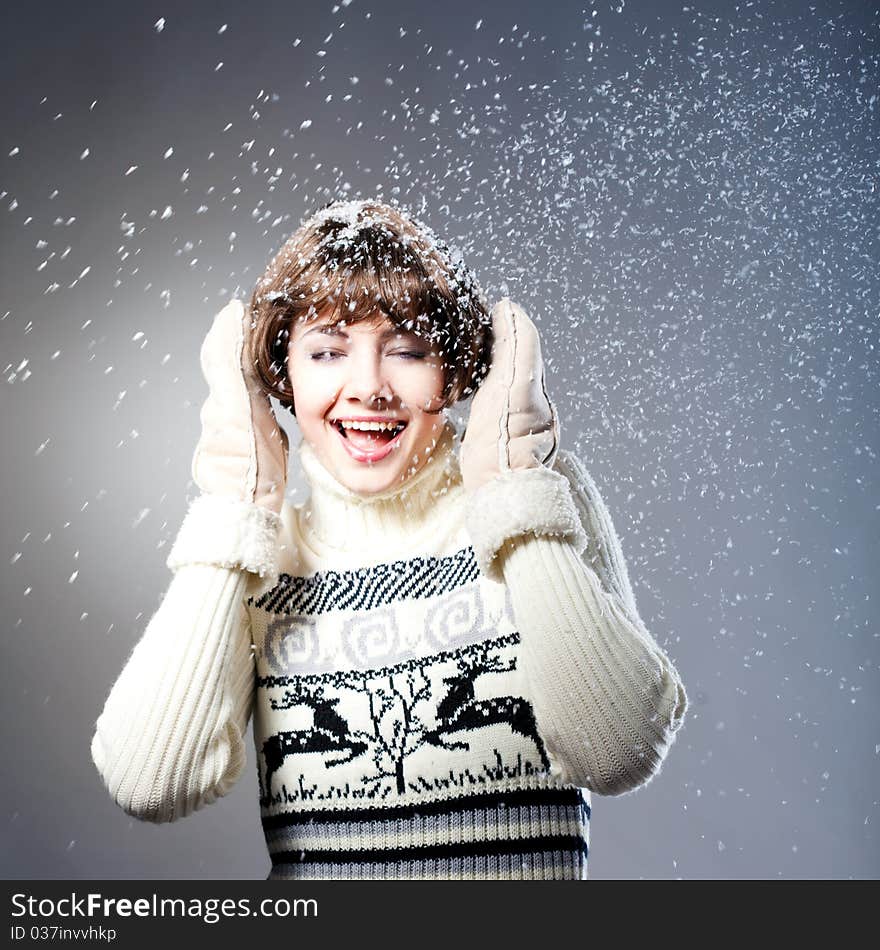 Young beautiful girl rejoices to snow