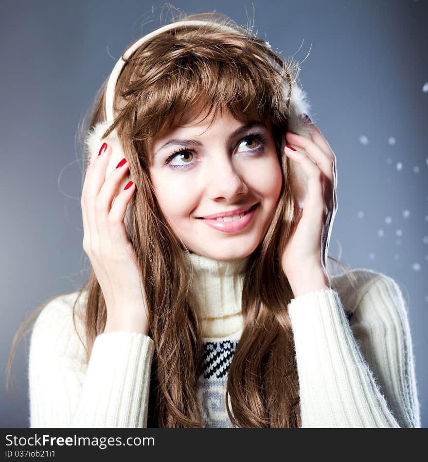 Young beautiful girl rejoices to snow, On a dark blue background