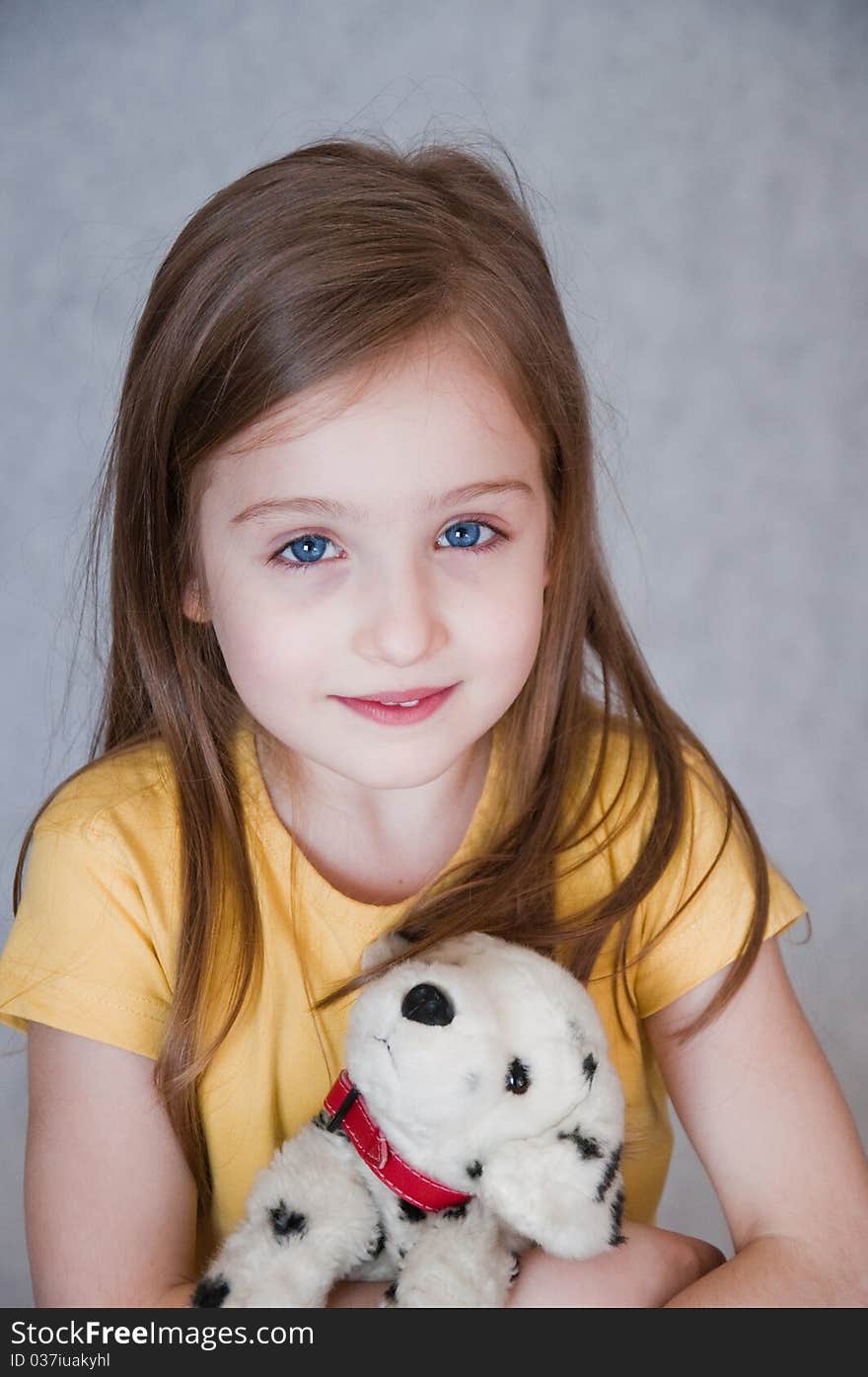 Portrait of little girl with toy dog