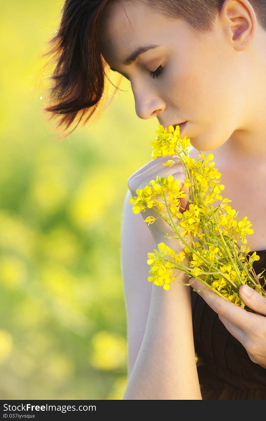 Young girl portrait holding yellow flowers with closed eyes. Young girl portrait holding yellow flowers with closed eyes.