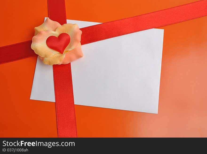 White card with rose petals. Postcard with heart on the orange background. Letter with a red ribbon. White card with rose petals. Postcard with heart on the orange background. Letter with a red ribbon.