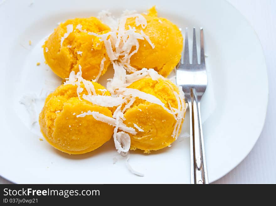 Dessert thai sweet sugar palm cake with coconut On a white plate