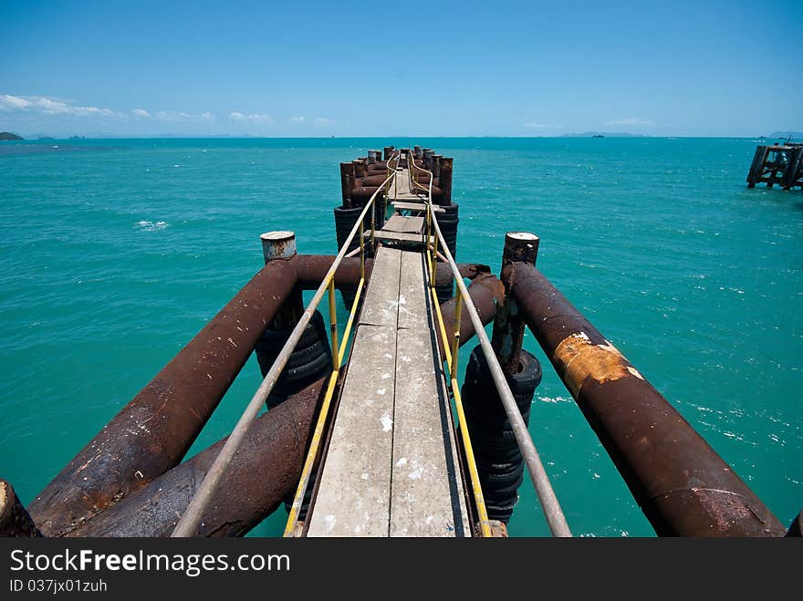 Perspective view of old bridge over the ocean. Perspective view of old bridge over the ocean.