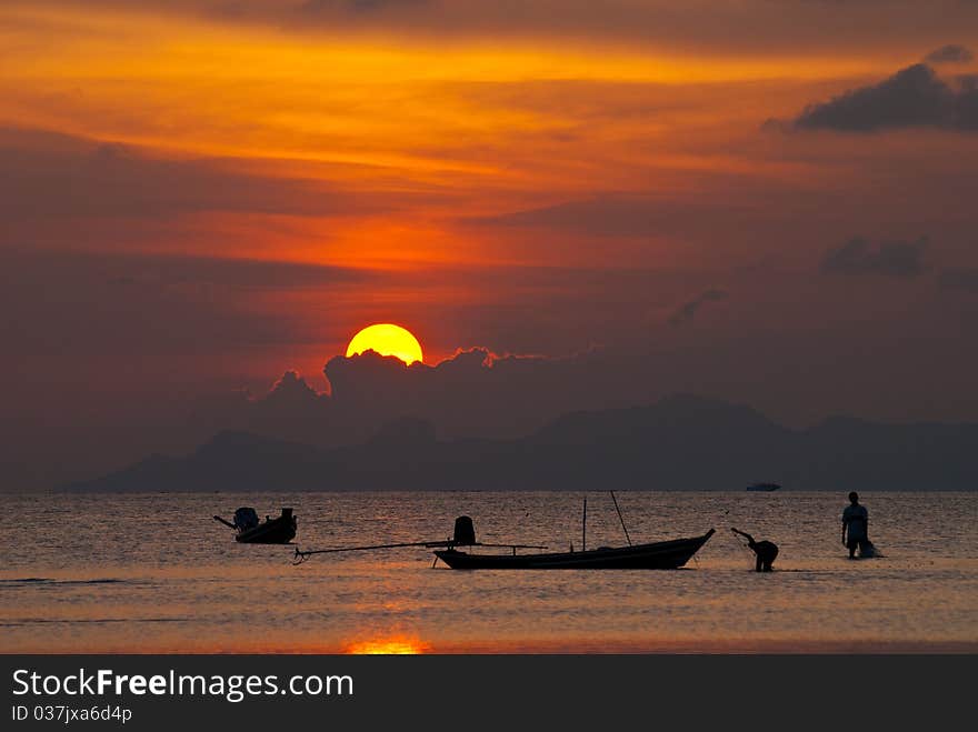 Two of young fisherman working at sunset. Two of young fisherman working at sunset.