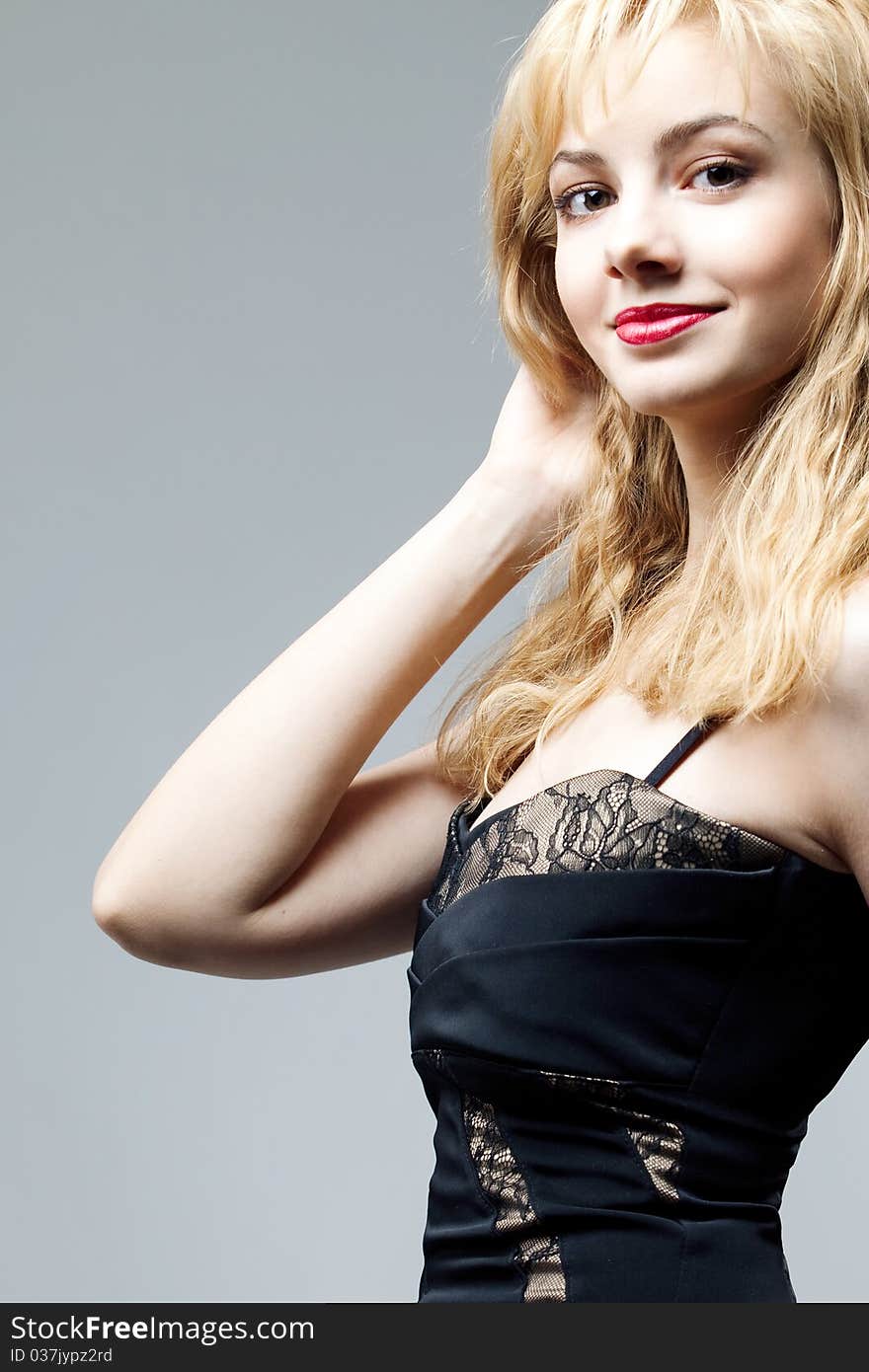 Young beautiful high blonde in a black dress