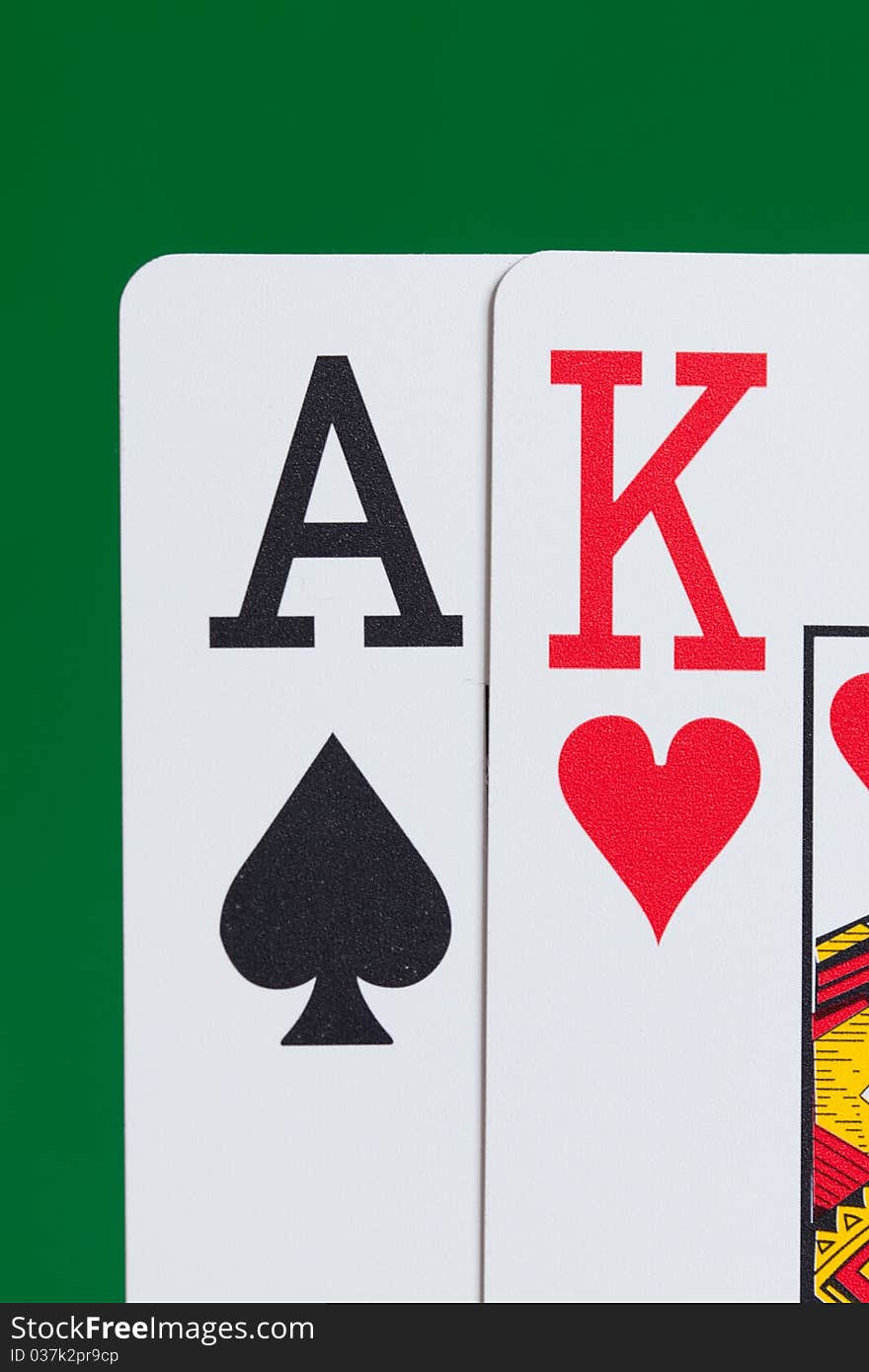 Close up of Ace and King playing cards on a green background