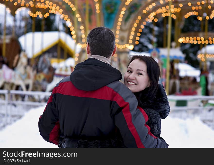 Happy couple looking at carousel