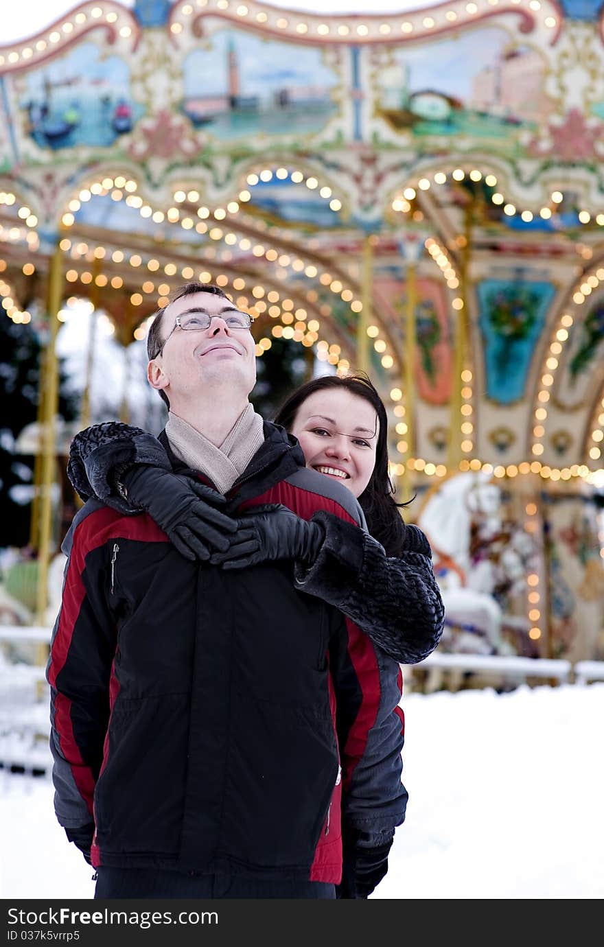 Happy Couple Looking At Carousel