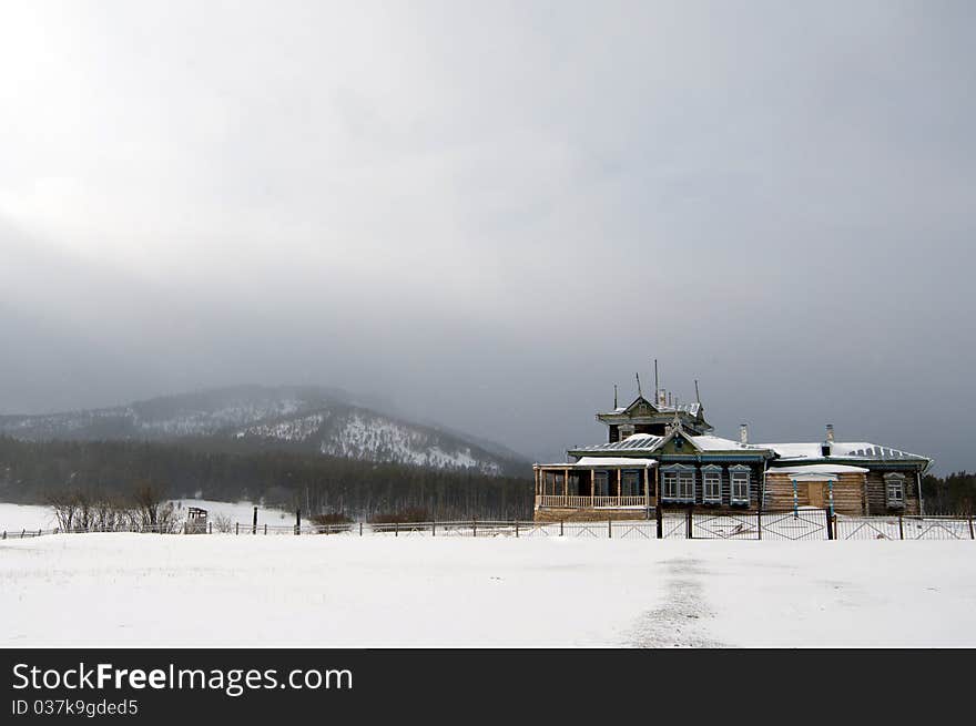 Winter scene in mountains. Old house and snow. Winter scene in mountains. Old house and snow