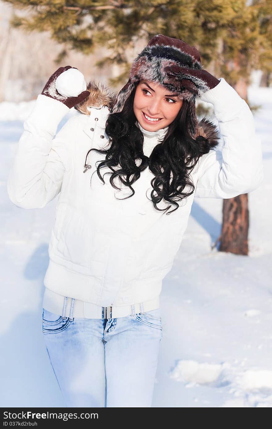 Beautiful girl on a walk in a winter park