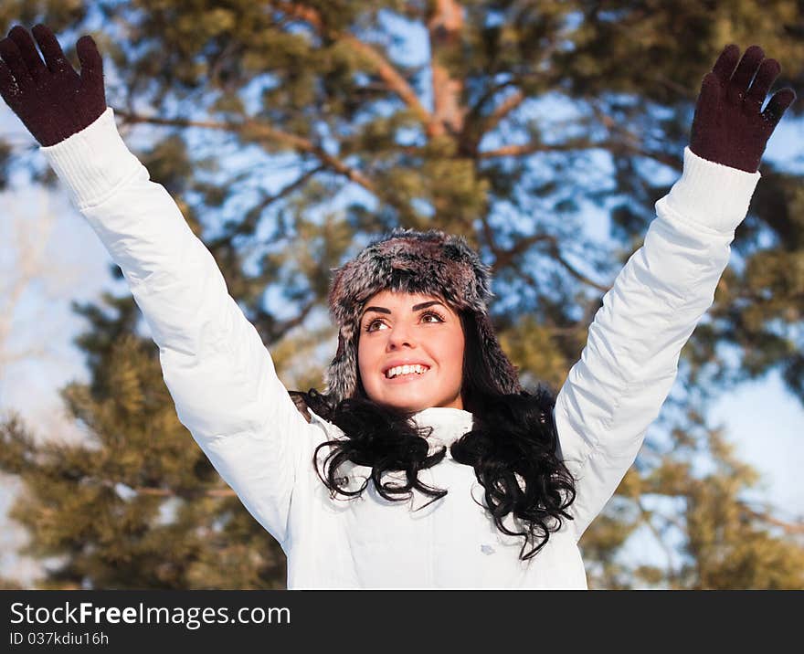 Beautiful girl on a walk in a winter park