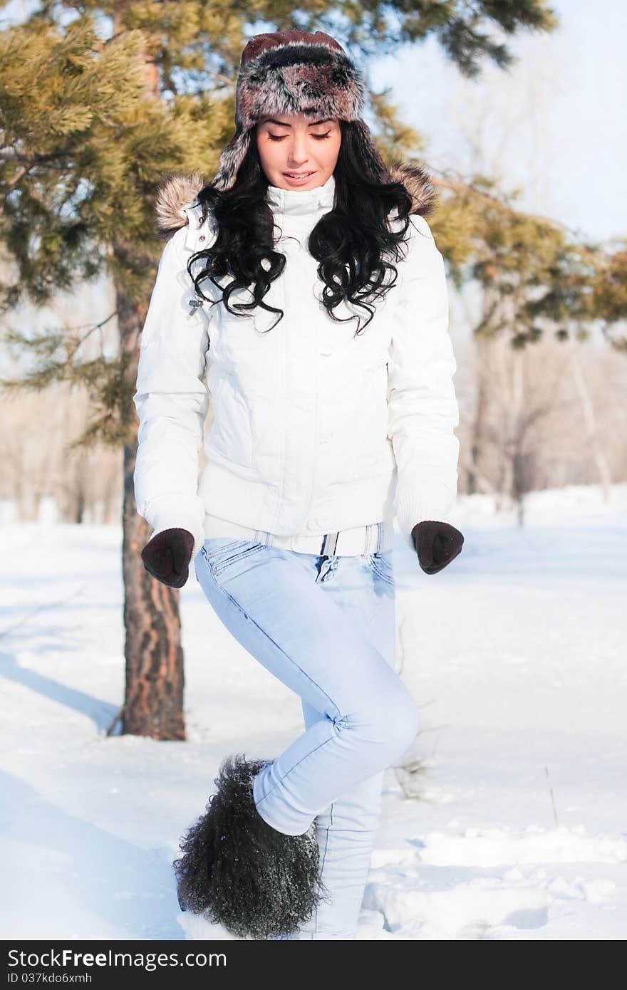 Beautiful girl on a walk in a winter park