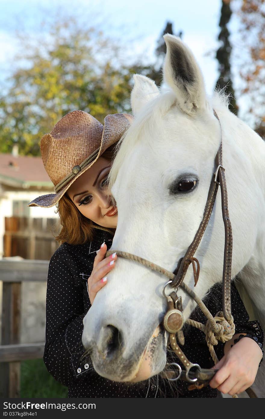 Cowgril petting her beautiful white horse. Cowgril petting her beautiful white horse