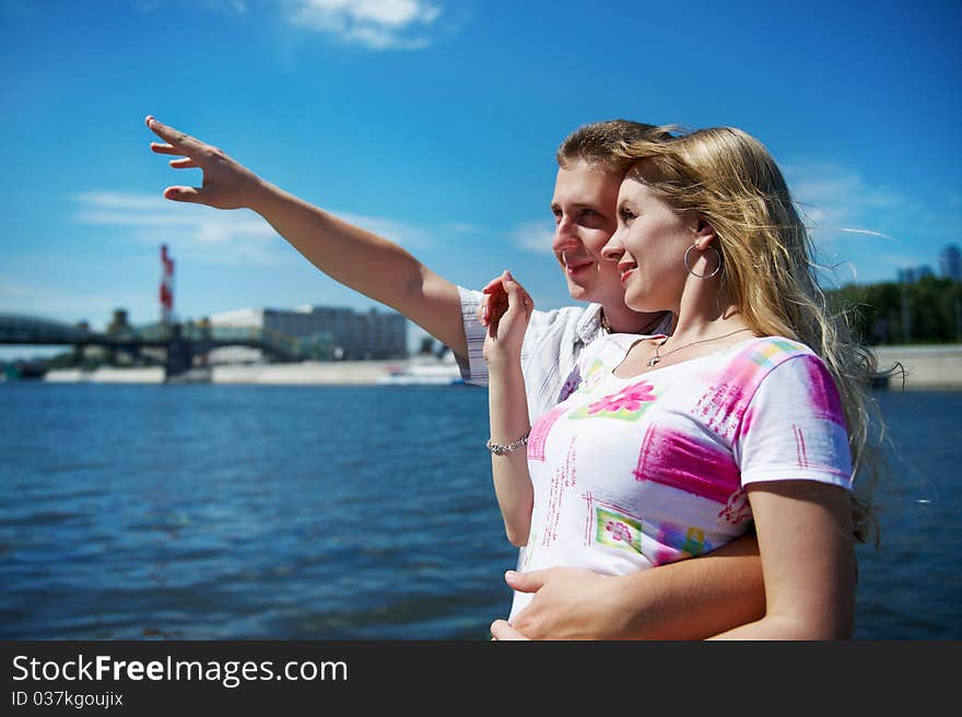 Young man show his girlfriend that in the distance on sky