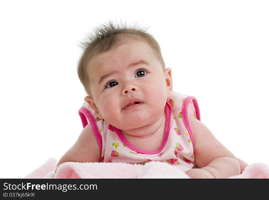 Cute asian-caucasian baby on pink towel looking up, isolated on white background. Cute asian-caucasian baby on pink towel looking up, isolated on white background