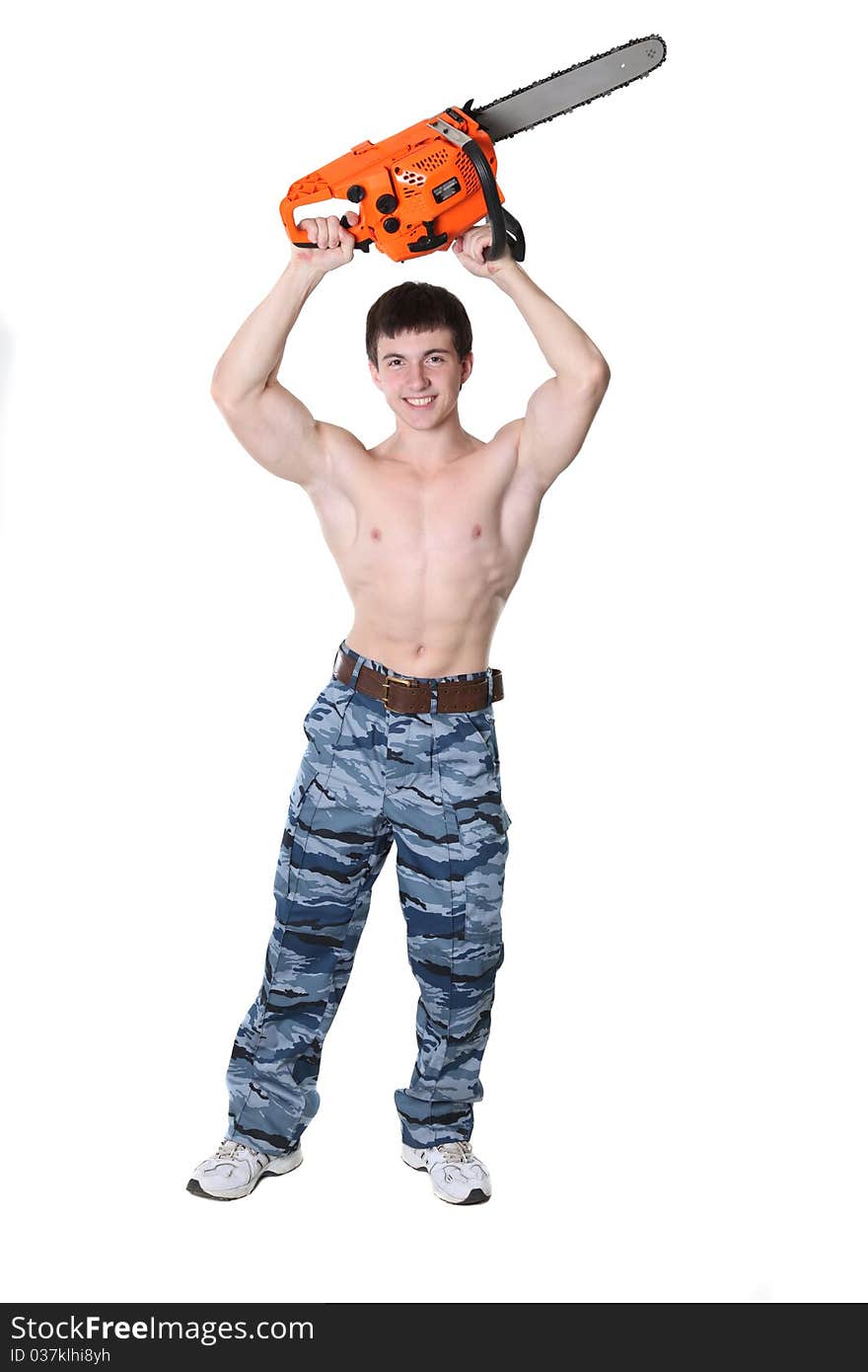 Strong man in military trousers with chainsaw in hands