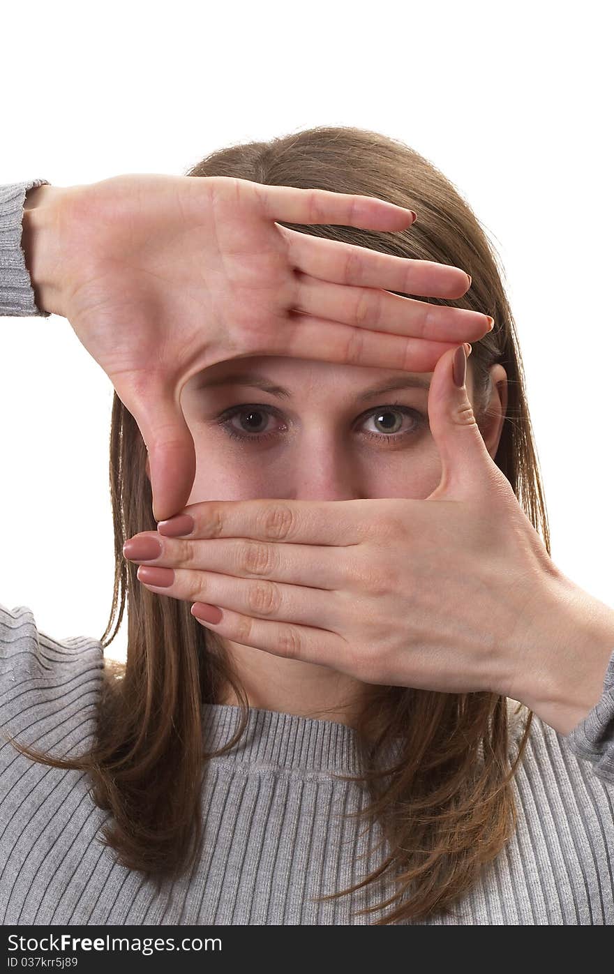 Young woman in grey sweater with hands frame isolated over white background