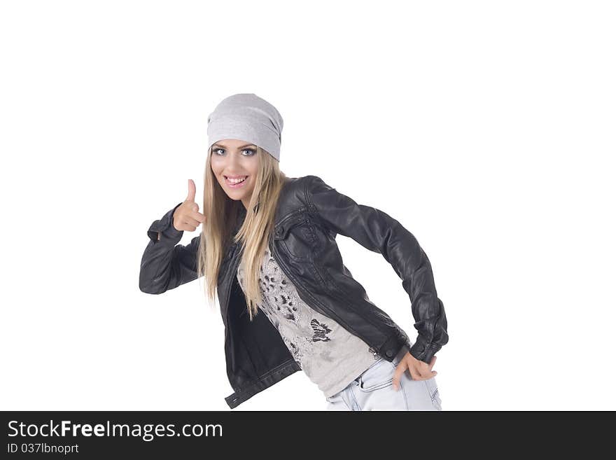 Emotional, glamour girl on a gray background, in a leather jacket and in a cap