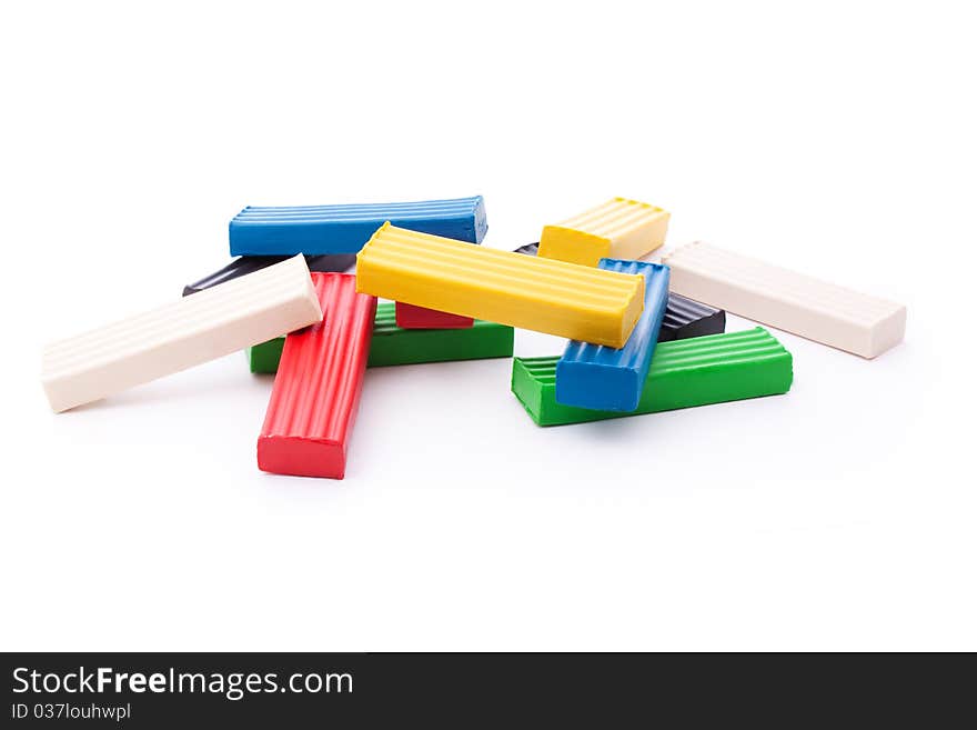 Multicolored plasticine sticks isolated on white