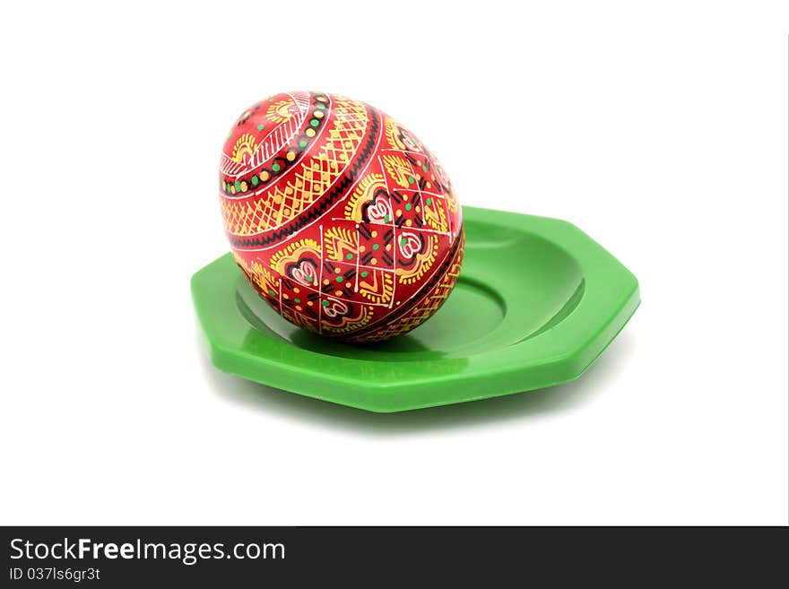 Painted wooden egg on a plate green. Painted wooden egg on a plate green