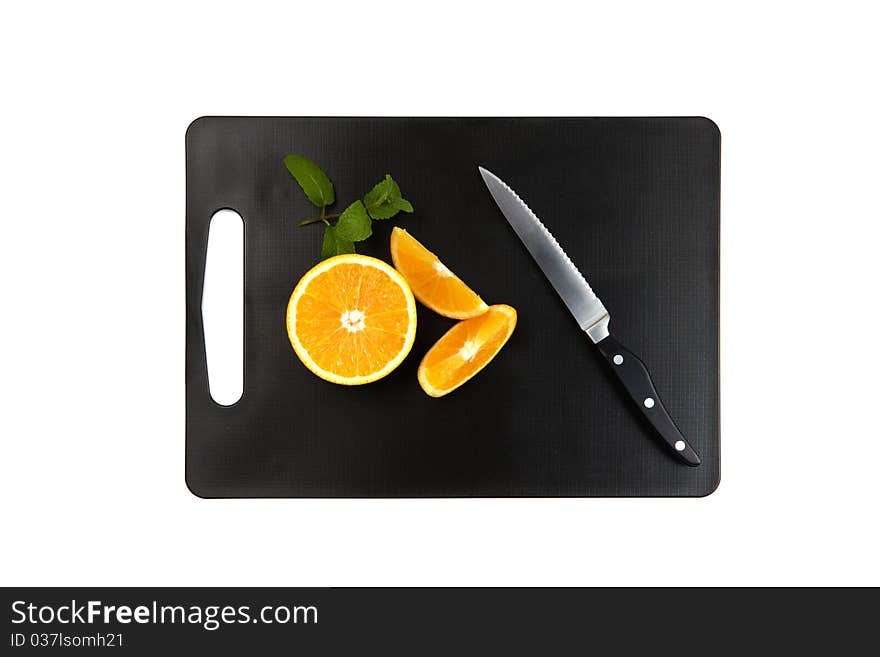 Black cutting board with oranges, mintleaf and knife isolated on white background. Black cutting board with oranges, mintleaf and knife isolated on white background