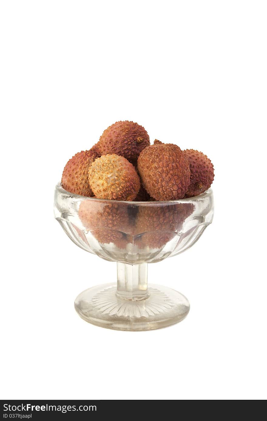 Lychees in glass vase isolated on white background