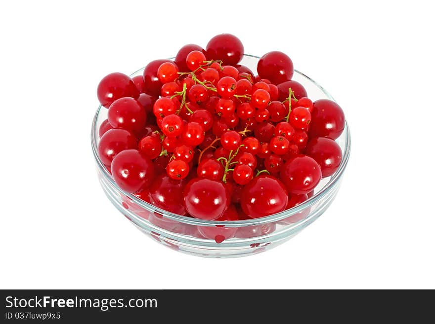 Sweet cherries and currants in glass bowl isolated on white