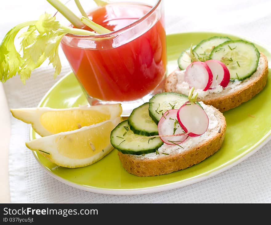 Healthy sandwiches with radish and cucumber on plate with tomato juice. Healthy sandwiches with radish and cucumber on plate with tomato juice