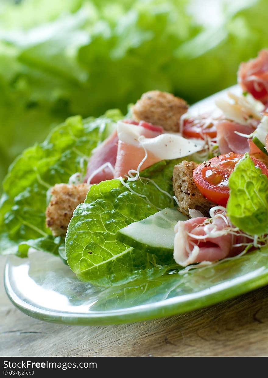 Fresh salad from vegetables, cheese and ham