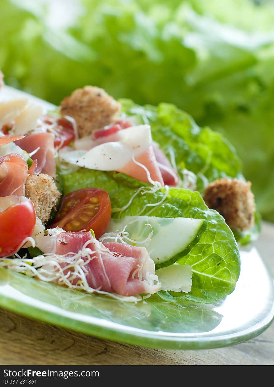 Fresh salad from vegetables, cheese and ham