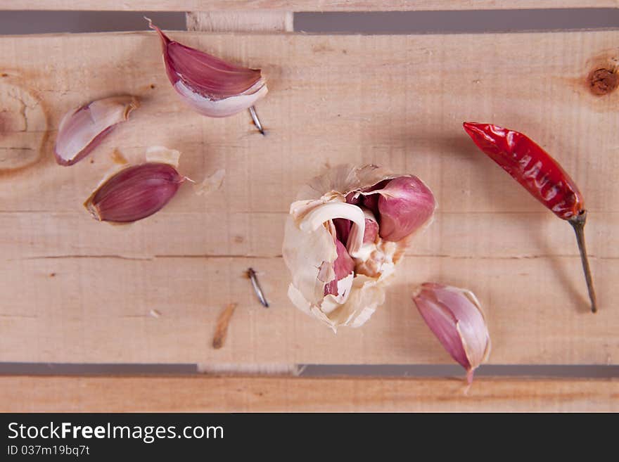 Garlic and dry pepper on old wood. Garlic and dry pepper on old wood