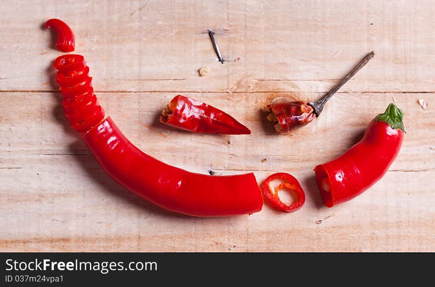 Sliced red hot chili pepper and little dry pepper on wooden desk. Sliced red hot chili pepper and little dry pepper on wooden desk