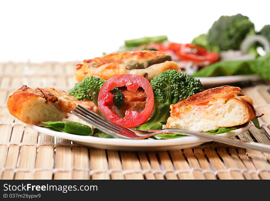 Plate of fresh vegetablles with bread on wooden mat. Plate of fresh vegetablles with bread on wooden mat.