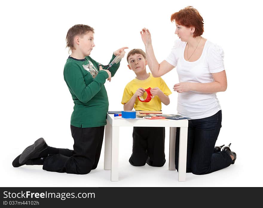 Mother with children involved in scrapbooking table