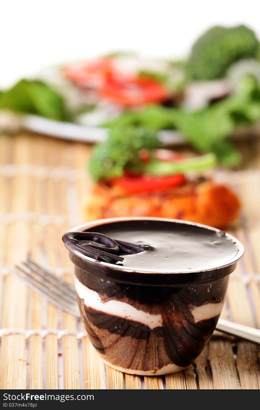 Chocolate pudding looking yummy over wooden background. Chocolate pudding looking yummy over wooden background.