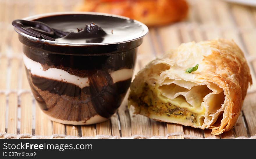 Chocolate pudding with danish pastry over wooden background. Chocolate pudding with danish pastry over wooden background.