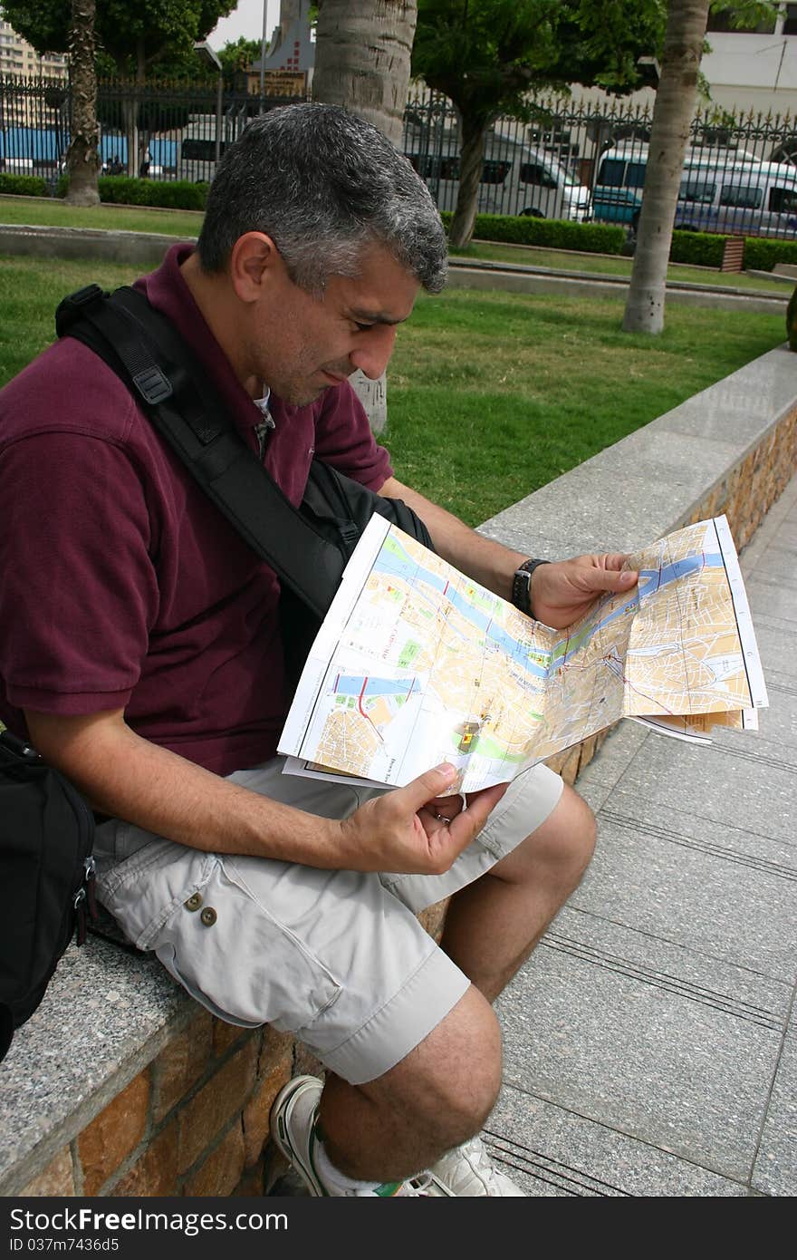 A tourist in Cairo Egypt is looking at a map. A tourist in Cairo Egypt is looking at a map.