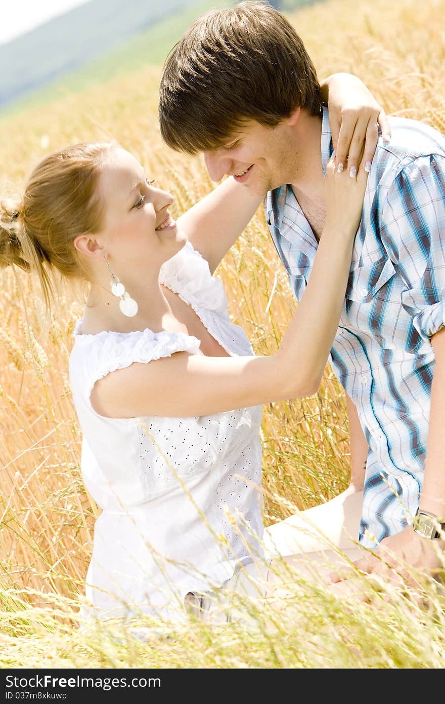 Young couple sitting in grain field