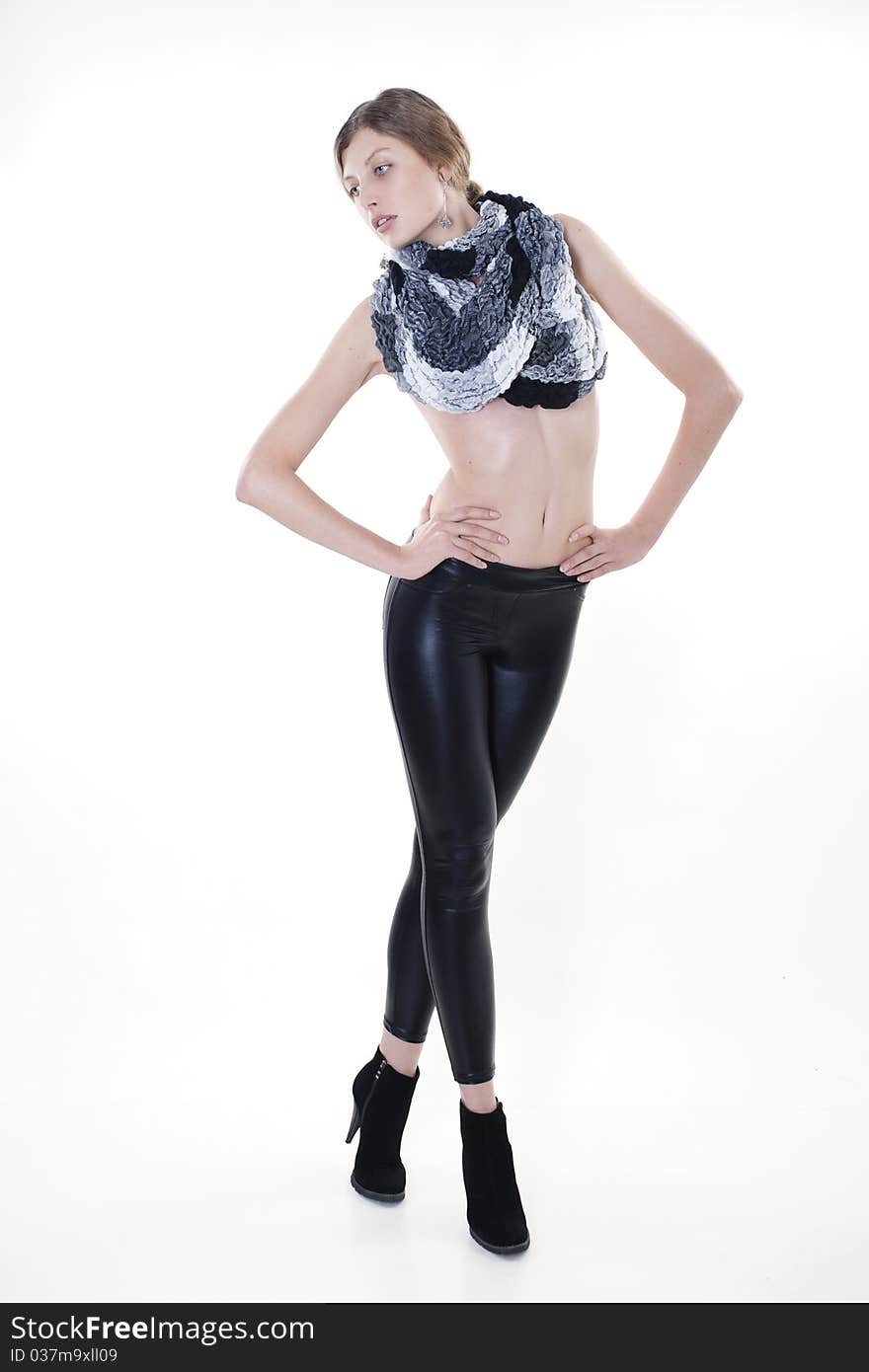 Fashion model posing in leggings and a scarf on a white background