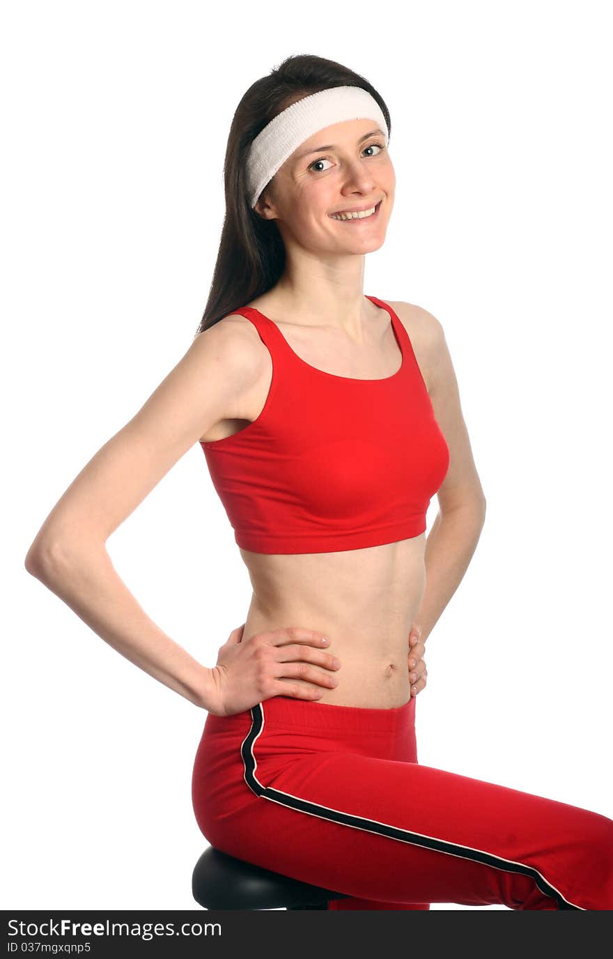 Happy young woman in red sport clothes exercising; isolated on white. Happy young woman in red sport clothes exercising; isolated on white