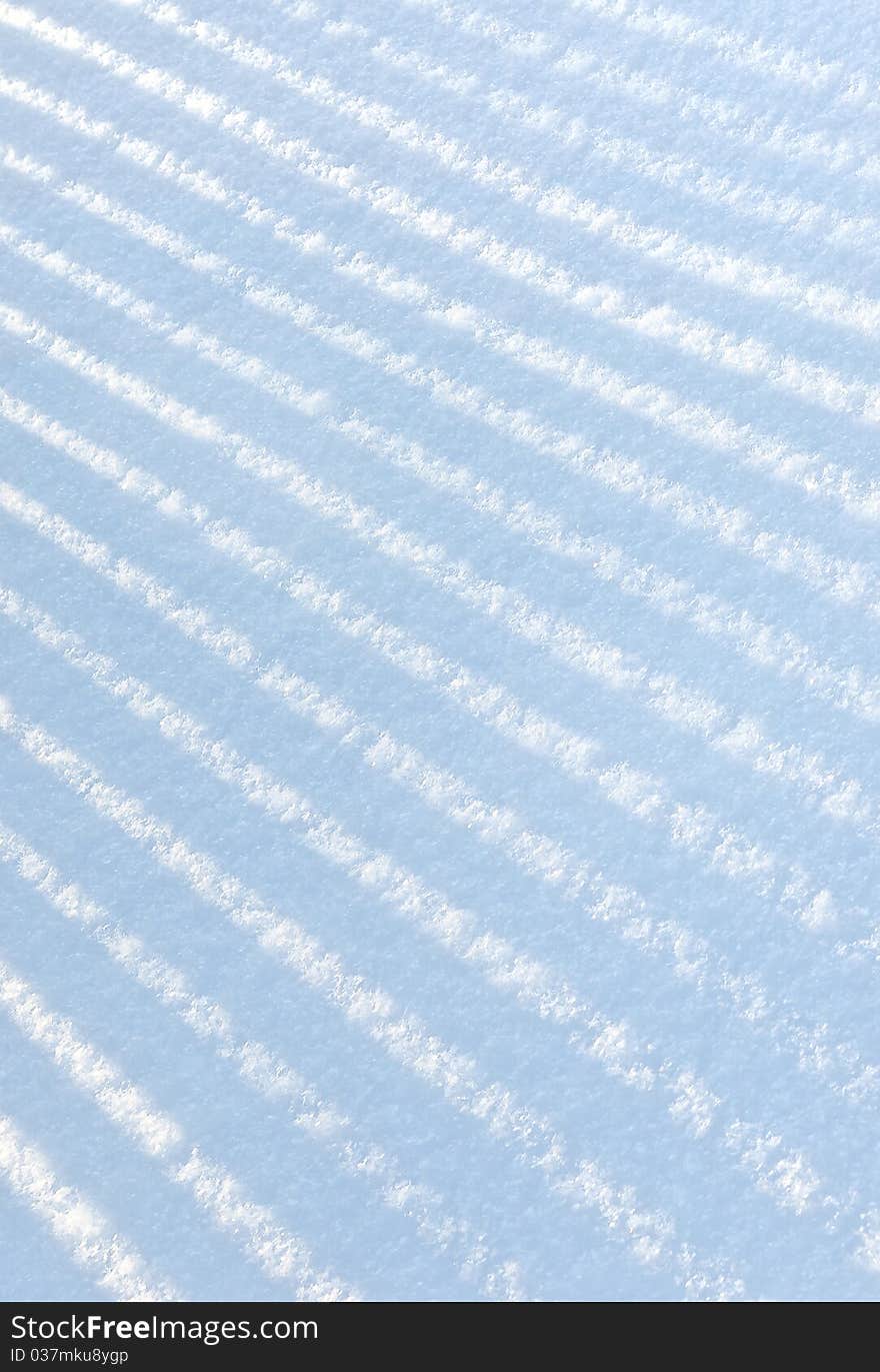 Shade from a picket  fencing on fresh snow. Shade from a picket  fencing on fresh snow